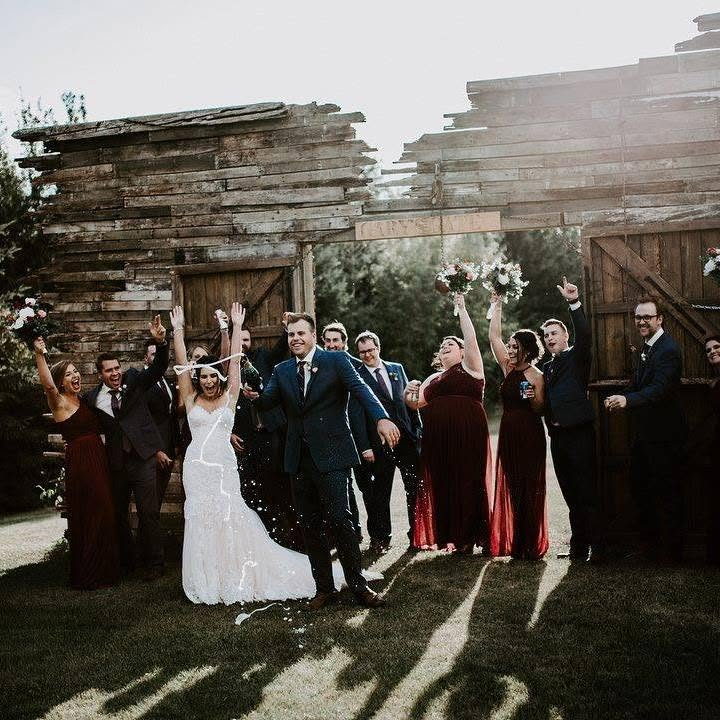 Wedding party celebrating at the barn doors