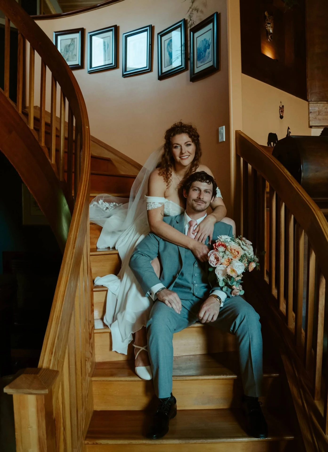 Newlyweds on the curved wooden staircase